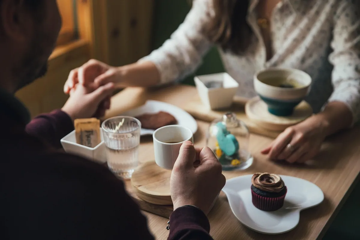 Two people in an honest conversation over coffee